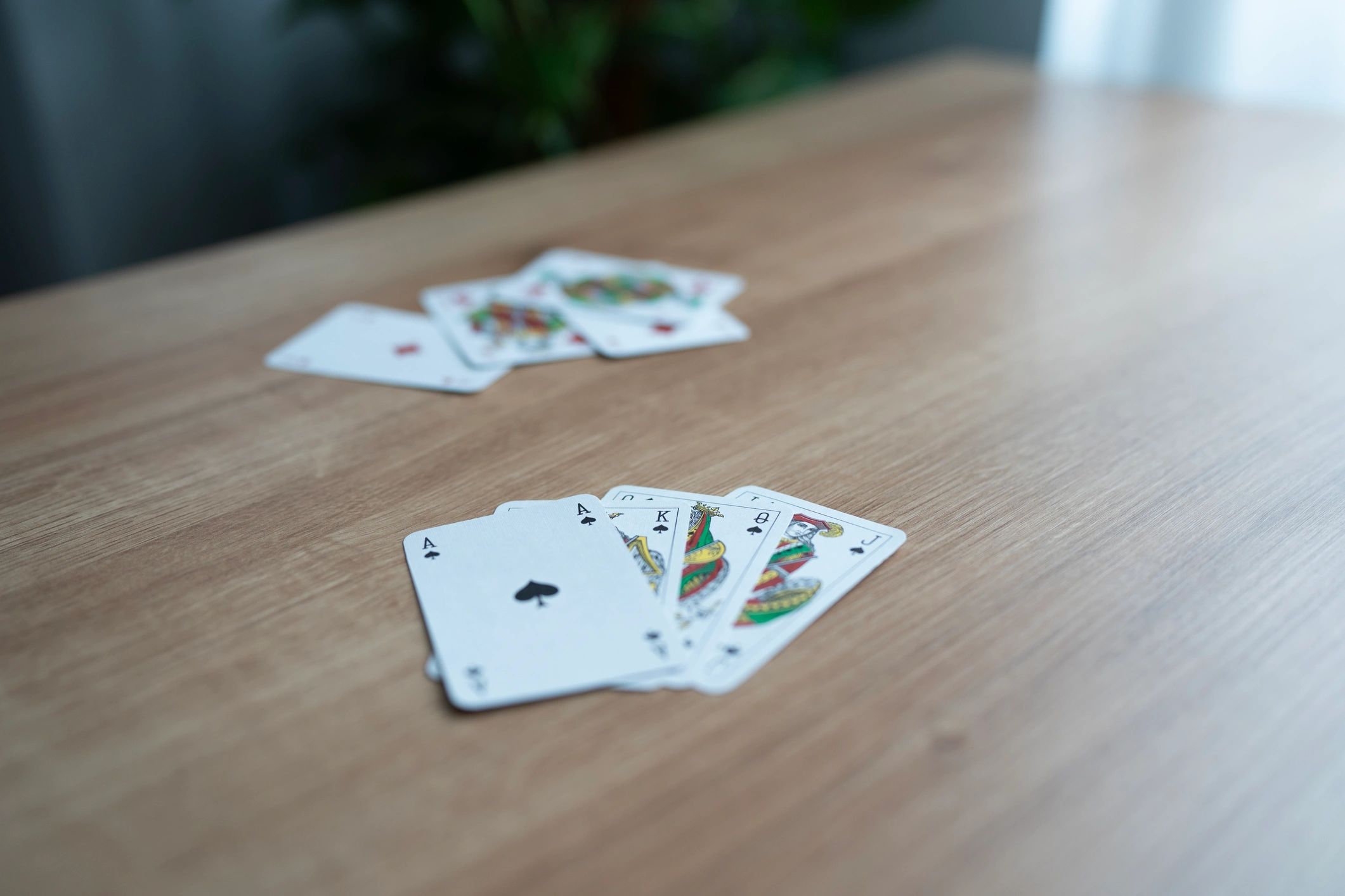 Playing cards spread on a wooden table